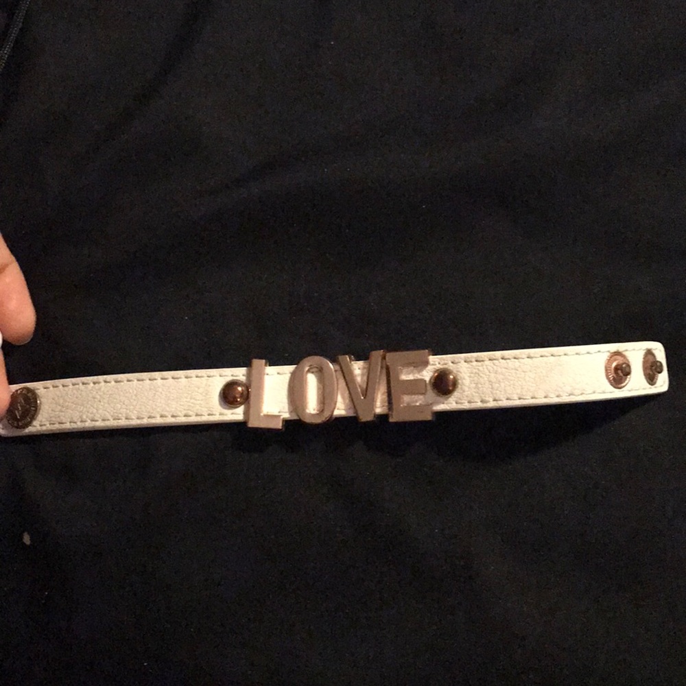 Cream colored bracelet with gold love letters